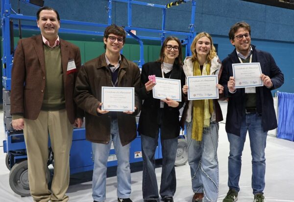 The winning team of the Shot Glass Competition poses for a photo with ACerS President Mario Affatigato.